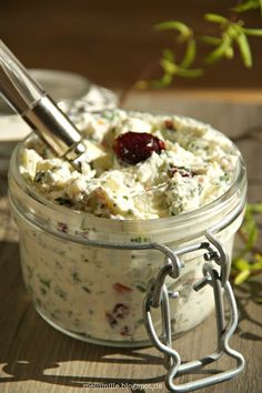 a jar filled with food sitting on top of a wooden table