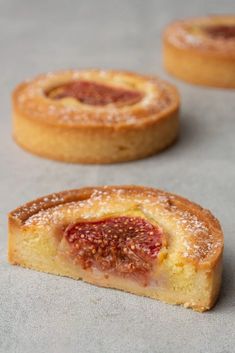 three pastries sitting on top of a table next to each other, with one slice cut out