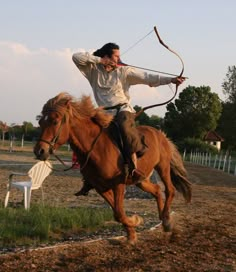 a man riding on the back of a brown horse