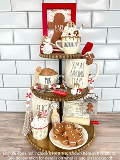 a three tiered tray with cookies, hot chocolates and mugs on it