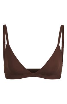 Enjoy the comfort of a bralette while retaining the breathability of quick-dry fabric with this comfortable option from Kim Kardashian West's SKIMS. Available in nine different shades, this second-skin triangle bra offers natural support and comfort while you read, lounge and sleep. Adjustable straps Quick-dry, max-stretch technology Lined 76% polyamide, 24% elastane Hand wash, dry flat Imported Lingerie Fitted Seamless Brown Sports Bra, Fitted Brown Seamless Sports Bra, Fitted Nursing Bra With Removable Pads For Everyday, Bra With Removable Pads And Minimal Stretch, Everyday Nursing Bra With Removable Pads, Fitted Full Coverage Everyday Bra, Fitted No-show Bra With Adjustable Straps, Fitted Seamless Bra In Elastane, Fitted Bra For Everyday Wear