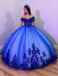 Step into your dream Quinceanera with the Fiora Ball Gown. This exquisite gown features a classic ball gown silhouette, beautifully crafted from layers of luxurious tulle fabric that add volume and movement to your every step. It is available in vibrant colors like royal blue, red, pink, purple, and green. The lace-up back ensures a perfect fit, accentuating your figure while adding a touch of classic charm. The intricate applique details and delicate beading sparkle with every turn, making you Aqua Blue Sweet 16 Dress, Azul Rey Quinceañera Dresses, Sweet 15 Dresses Quinceanera Blue, Xv Dresses Royal Blue, Royal Blue 15 Dress, 15 Dresses Quinceanera Royal Blue, Xv Dresses Blue, Quinceanera Dresses Royal Blue, Royal Blue Sweet 16 Dresses