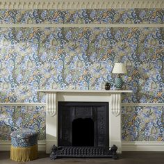 a fireplace in a living room next to a wall paper