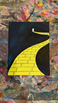 a painting with yellow brick on the side and black road going up it's sides