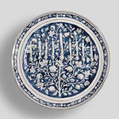 a blue and white plate with floral designs