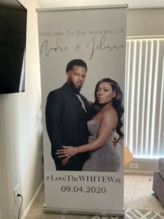 a sign advertising a wedding with a photo of the bride and groom on it in front of a window