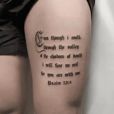 a woman's thigh with a bible verse tattoo on it