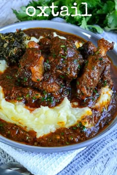 a plate filled with meat and potatoes covered in gravy