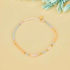 Pretty pastels with a story to tell this summer. The mixed seed bead Pineapple Crush Stretch Anklet features a patterned design of four summery shades with gold spacer seeds placed in between. String on durable nylon cord that adjusts and stretches to any size Length of anklet is 9" Because jewelry products are handcrafted by artisans, dimensions may vary from piece to piece Trendy Summer Friendship Bracelets With Tiny Beads, Gold Bohemian Beaded Bracelets For Spring, Casual Beaded Bracelets With Small Beads For Summer, Spring Gold Beaded Bracelets With Colorful Beads, Casual Friendship Bracelets With Gold Beads, Casual Tiny Beads Bracelets For Spring, Casual Tiny Beads Bracelet For Spring, Casual Tiny Beaded Bracelets For Spring, Adjustable Colorful Beads Friendship Bracelets For Spring