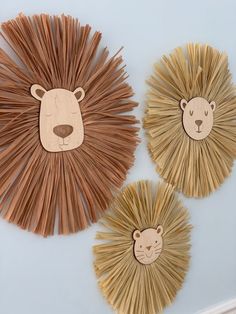 three lion and bear wall hangings made out of wood sticks with faces on them