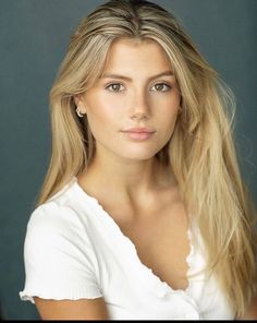 a woman with long blonde hair posing for a photo