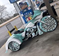 a motorcycle is parked at a gas station