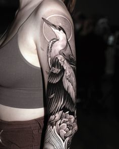 a woman with a bird tattoo on her arm