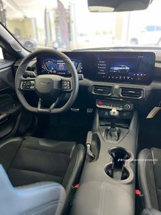 the interior of a car with dashboard, steering wheel and infotains on display