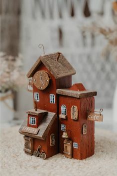 a small red house with a clock on it