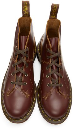 Ankle-high polished leather boots in burgundy. Round toe. Six-eye lace-up closure in brown. Logo webbing pull-loop in brown and yellow at heel collar. Signature yellow stitching at welt. Tonal signature Air Cushion rubber sole. Antiqued gold-tone hardware. Contrast stitching in yellow.Supplier color: Oxblood Church Monkey Boots, Oxblood Boots, Dr Martens Burgundy, Monkey Boots, Brown Logo, Boots Outfit, Luxury Streetwear, Leather Boots, Rubber Sole