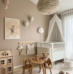 a baby's room with a crib, table and chairs