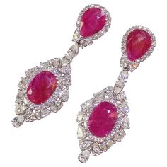 This extravagantly bold pair of earrings are not for the faint of heart! 1 6.74 carats of deep red pear-shaped and oval-shaped rubies take center stage in these modern design drop earrings. The 6.86 carats of round,pear and oval cut white diamonds hold their own in this extravagant 18K white gold drop. Luxury Red Diamond Earrings With Gemstone, Luxury Ruby Diamond Earrings For Anniversary, Red Pear, Fancy Diamonds, Dream Jewelry, Center Stage, Ear Jewelry, Deep Red, Pear Shaped