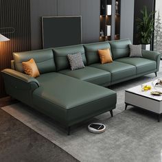 a green leather couch sitting on top of a gray rug next to a white coffee table