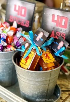 two buckets filled with assorted candies on top of a table