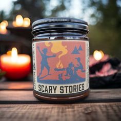 a jar of scary stories candle sitting on a table