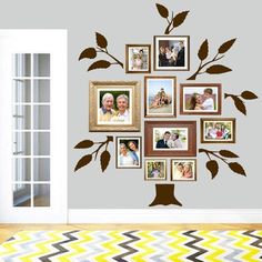 a family tree with pink leaves and pictures on the wall in front of an open door