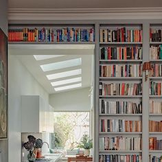 a kitchen with lots of books on the shelves