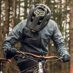 a man riding on the back of a bike wearing a helmet