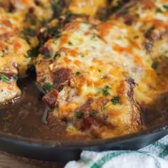 a close up of a pizza in a pan on a table