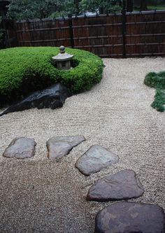 a garden with rocks and gravel in the middle