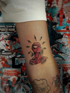 a spider man tattoo on the arm