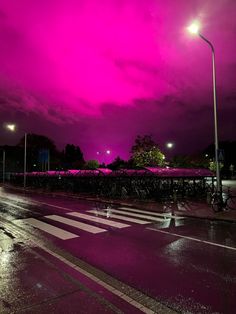 a purple sky is seen over a city street