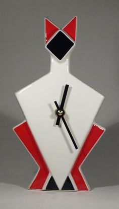 a clock with an orange and black design on it's face is shown in front of a gray background