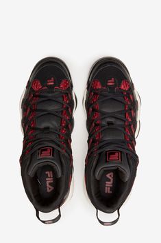 a pair of black and red sneakers on a white background