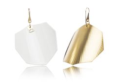 two white and gold earrings on a white background with reflections in the foreground, one is shaped like an origami leaf