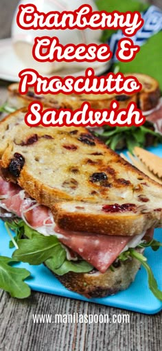 a sandwich with ham, cheese and prosciutto on it sitting on a blue plate