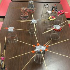 a long table with many cups and toothpicks in them on sticks that are stuck to the top of each other