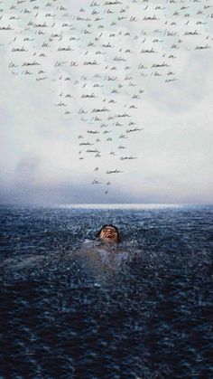 a man swimming in the ocean with many words written on it's back side