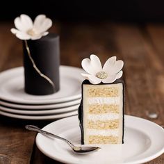 a piece of cake sitting on top of a white plate next to a black and white vase