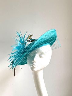 Aqua fascinator hat Aqua saucer disc hat is made from sinamay fabric. On the side is sitting aqua, white and gold feathers. Aqua Saucer Disc Hat will be an amazing accessory to compliment your outfit. It's very elegant and original. Aqua Blue saucer disc hat will fit the average head size. To secure your fascinator there is a black rubber band inside the hat attached, so the fascinator sits very securely on your head. Enjoy your special day with this beautiful headpiece and please have a look at Teal Fascinator, Sinamay Fabric, Black Rubber Bands, Blue Disc, Fascinator Wedding, Kentucky Derby Fascinator, Blue Fascinator, Royal Ascot Hats, Derby Fascinator