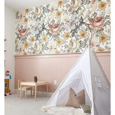 a child's playroom with a teepee tent in the corner and floral wallpaper on the walls