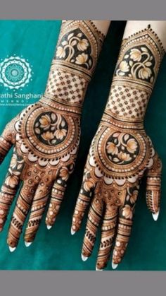 two hands with henna designs on them