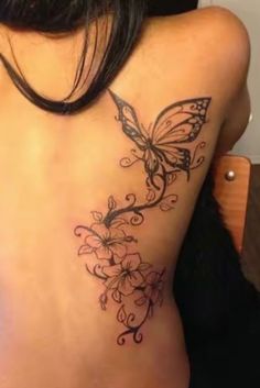 a woman with a butterfly tattoo on her back