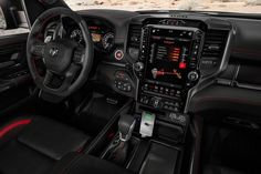 the interior of a car with black and red trims