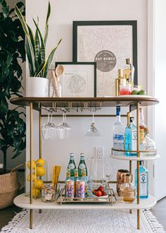 a bar cart with drinks on it in a room