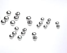 several silver balls on a white background