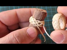 two hands are holding twine wrapped nuts