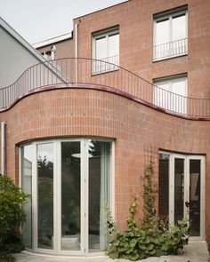 a red brick building with white windows and stairs