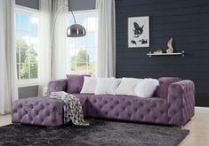 a living room with purple couches and white pillows