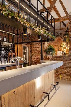 a bar with brick walls and exposed ceilings